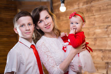 Mom with two children of twelve years and eleven months of age in the roomの写真素材