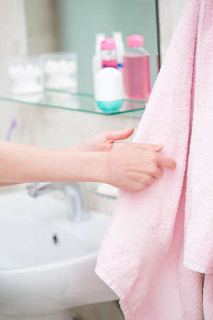 The boy is washing his hands in the bathroomの写真素材