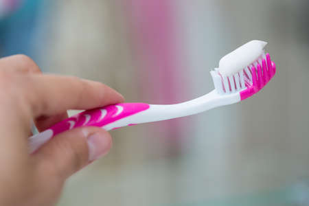 Toothbrush in the hand of a teenagerの写真素材