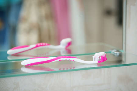 Toothbrushes in the bathroom on the shelfの写真素材