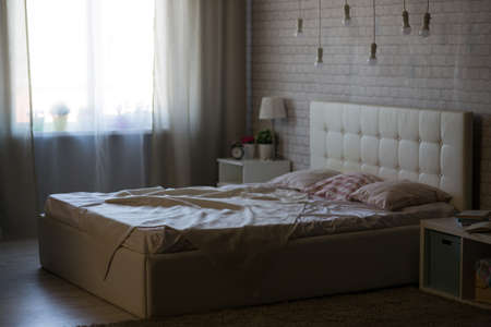 White bed in the interior of the bedroom