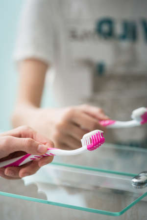 Toothbrush in the hand of a teenagerの写真素材
