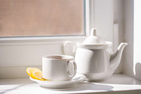 A cup of tea on the windowsillの写真素材