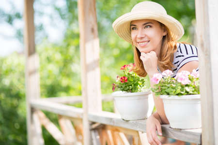 Young woman in a summer gardenの写真素材
