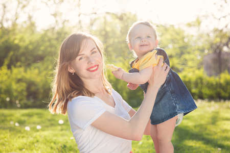 Young woman with baby resting in the parkの写真素材