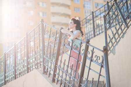 Beautiful young woman is walking around the cityの写真素材