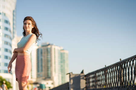 Beautiful young woman is walking around the cityの写真素材