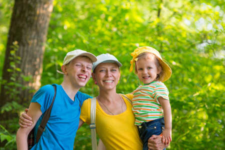 Mother with two children outdoorsの写真素材