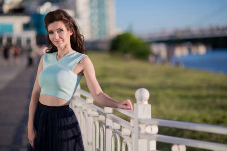 Beautiful young woman on the river bank