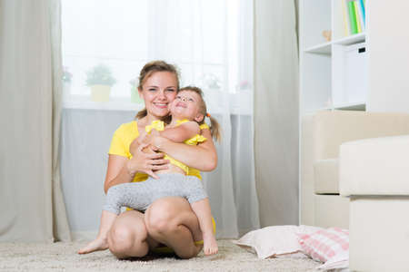Mom and daughter of two years playing in the room
