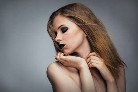 Young woman with bright make-up, studioの写真素材