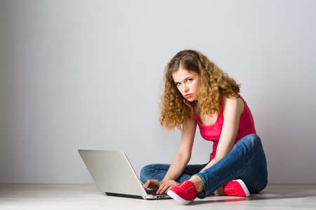 Young female student with laptopの写真素材