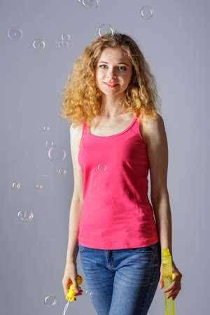 Beautiful young woman with soap bubblesの写真素材