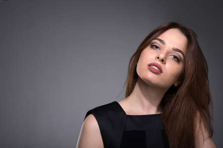 Young beautiful woman. Portrait in studio of young brunette womanの写真素材