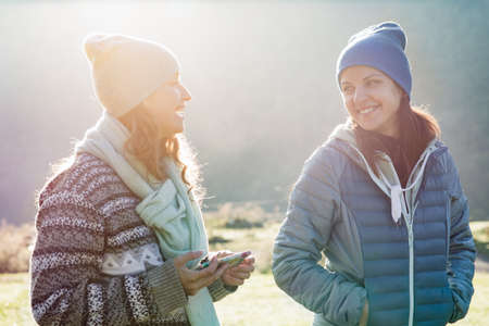 Two young women laughing in natureの写真素材