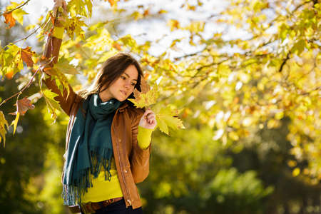 Young beautiful woman in autumn park