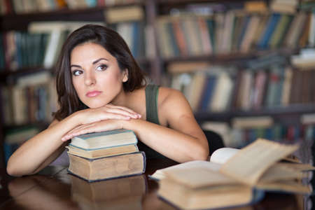 Beautiful young woman in a libraryの写真素材