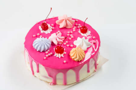 Pink cake decorated with marshmallow and cherry