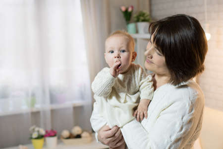 grandmother and granddaughter in the room, happy family with the baby