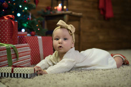 Baby six months under the Christmas tree, happy christmasの写真素材