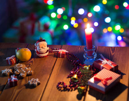 Christmas background on a table in a room with a decorated Christmas treeの写真素材
