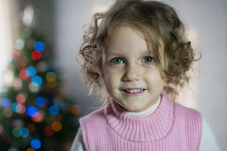 Girl in the room with a Christmas treeの写真素材