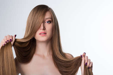 young woman with long beautiful hair, Young long-haired woman with well-groomed hair