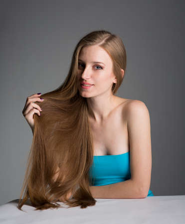young woman with long beautiful hair, Young long-haired woman with well-groomed hairの写真素材