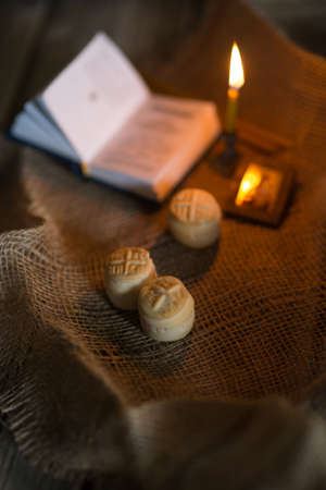 Prosfora from the Orthodox Church and a burning candleの写真素材