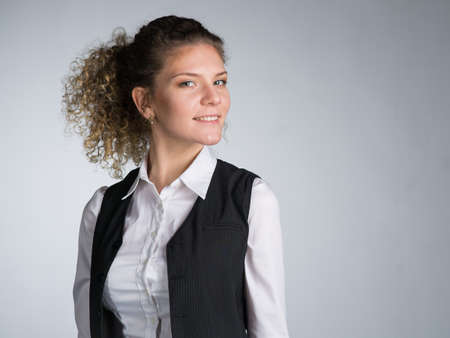 Young business woman on gray background, studio.の写真素材