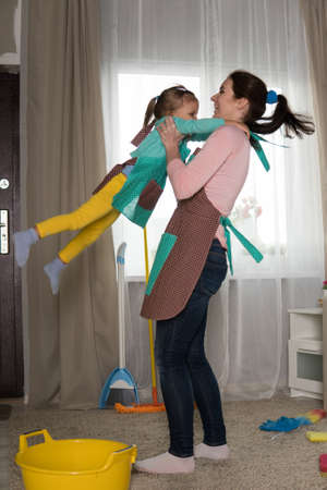 Mom and daughter are cleaning in the apartment, a woman and a girl of three years doing household...