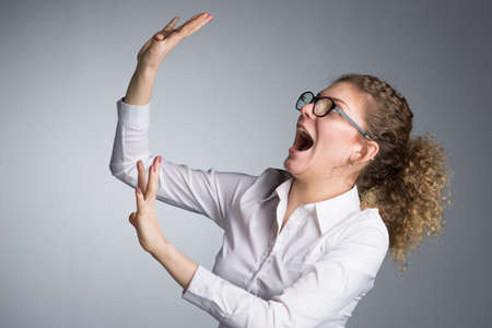 Young business woman on gray background, studio.の写真素材