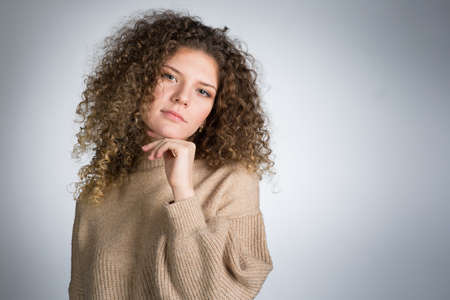 Young woman with curly hair, studioの写真素材