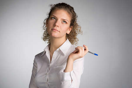 Young business woman on gray backgroundの写真素材