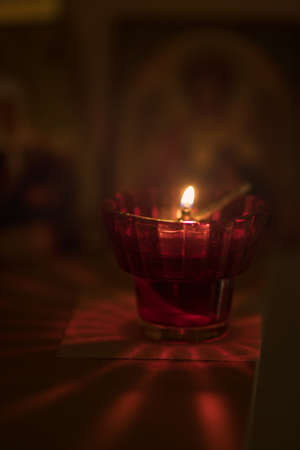 Burning lamp in a room with orthodox icons