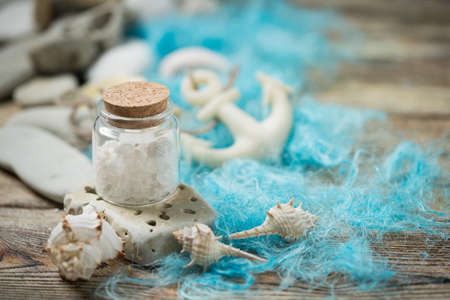 Beautiful composition of seashells and stones on a marine theme on old boardsの写真素材