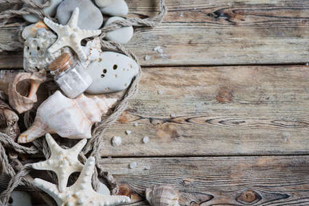 Beautiful composition of seashells and stones on a marine theme on old boardsの写真素材