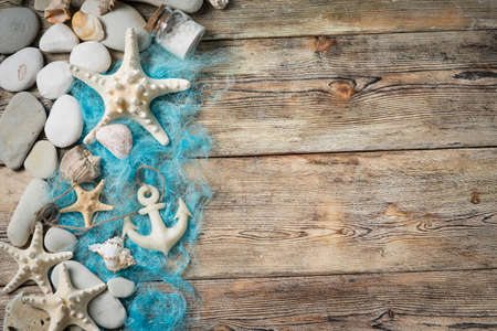 Beautiful composition of seashells and stones on a marine theme on old boardsの写真素材