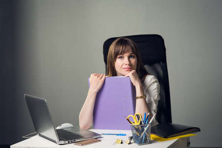 Young Businesswoman on a gray backgroundの写真素材