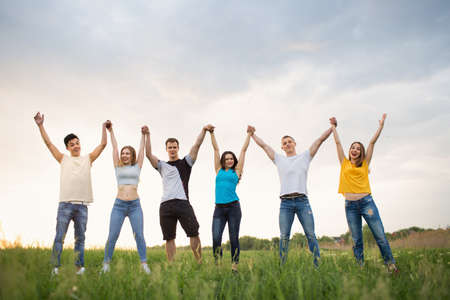 Young people  against the beautiful sunset sky