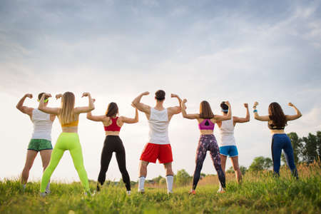 Group of sports people on the grass, young stand on the fieldの写真素材