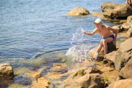 A guy on the beach, a boy of sixteen on vacationの写真素材