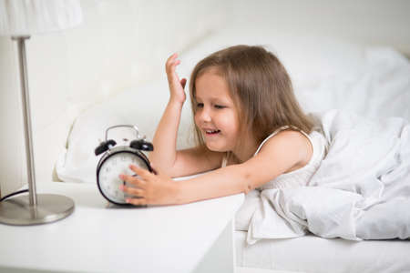 A girl of four years old sleeps in bedの写真素材