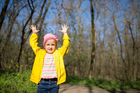 A girl of four years old walks in the forest in the springの写真素材