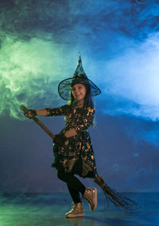 Baby girl in a witch costume for Halloweenの写真素材