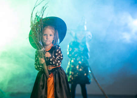 Two girls on Halloween dressed witchesの写真素材