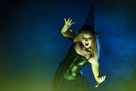 Young woman witch conjures, woman in costume on halloween
