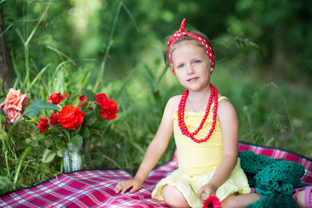 Little girl on a picnic in the summer in the forestの写真素材