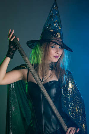 Young woman witch conjures, woman in costume on halloweenの写真素材
