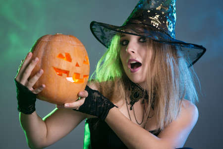 Young woman witch conjures, woman in costume on halloweenの写真素材